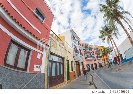 Tourist walking on colorful street in Puerto de la Cruz Tenerife with fisheye effect and copy space Tourist walking on colorful street in Puerto de la Cruz Tenerife with fisheye effect and copy space 141856691