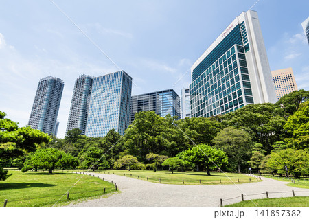 Path view of the Hama-rikyu Gardens and high-rise buildings near Shiodome in Chuo City, Tokyo, Japan. It was formerly the Tokugawa family's villa in the 17th century. Path view of the Hama-rikyu Gardens and high-rise buildings near Shiodome in Chuo City, Tokyo, Japan. It was formerly the Tokugawa family's villa in the 17th century. 141857382