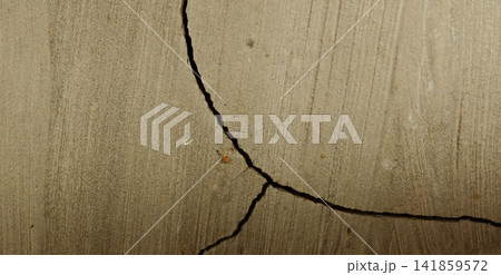 Curved cracks on the plastered concrete surface. Curved cracks on the plastered concrete surface. 141859572