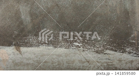 Dark concrete surface with white paint splatters and brushstrokes. 141859580