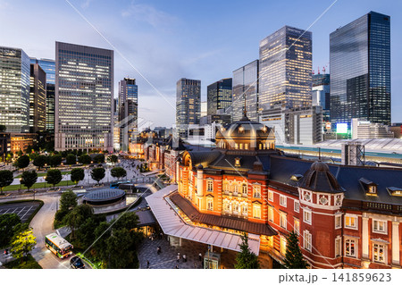 Night view of Tokyo Station. It's a major inter-city rail terminal in Chiyoda, Tokyo, Japan, with the Marunouchi and Yaesu high-rise business buildings in view.  141859623