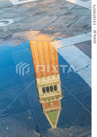 Creative Reflection of St. Mark's Campanile in a Puddle After Rain on Piazza San Marco, Venice, Italy Creative Reflection of St. Mark's Campanile in a Puddle After Rain on Piazza San Marco, Venice, Italy 141859974