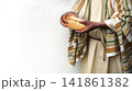 Man's hans holding fresh bread 141861382