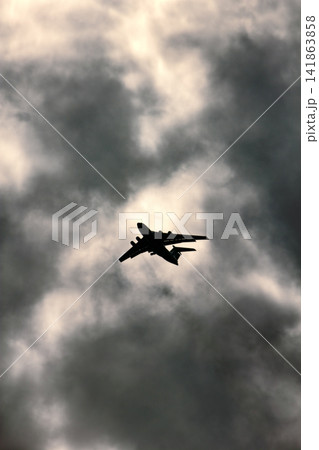Jet plane on background of cloudy sky Jet plane on background of cloudy sky 141863858