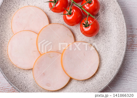 Slices of boiled chicken or pork sausage as an ingredient for home cooking. Sliced boiled sausage Slices of boiled chicken or pork sausage as an ingredient for home cooking. Sliced boiled sausage 141866320