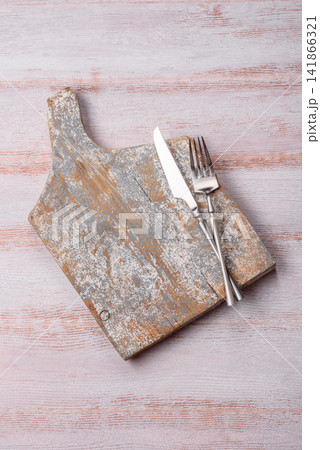 A square wooden cutting board for home food preparation. A wooden cutting board 141866321