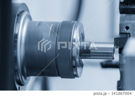 Thread making process on tube end using CNC lathe machine in blue tone lighting Thread making process on tube end using CNC lathe machine in blue tone lighting 141867004