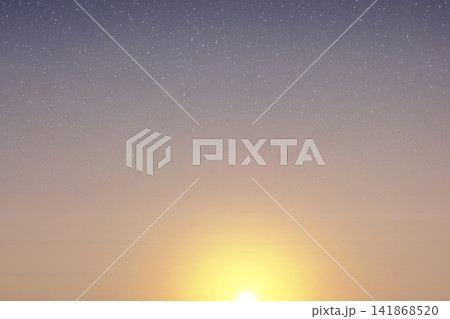 Sun shining bright below a starry twilight night sky with gradient colors and copy space. High Quality Photo Sun shining bright below a starry twilight night sky with gradient colors and copy space. High Quality Photo 141868520