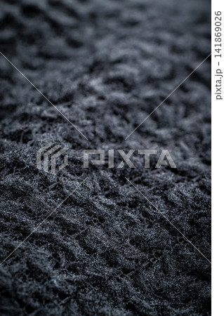 The fabric of black fleece, a synthetic knit with a soft, fluffy texture The fabric of black fleece, a synthetic knit with a soft, fluffy texture 141869026