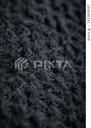 The fabric of black fleece, a synthetic knit with a soft, fluffy texture 141869047