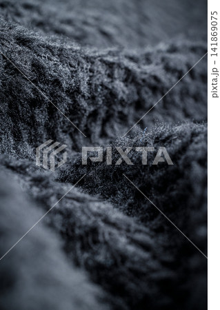 The fabric of black fleece, a synthetic knit with a soft, fluffy texture The fabric of black fleece, a synthetic knit with a soft, fluffy texture 141869075
