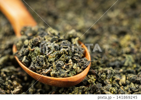 Premium dried oolong tea scoop on minimal solid background Premium dried oolong tea scoop on minimal solid background 141869245