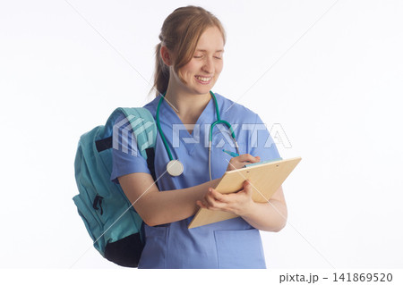 Smiling Student Nurse Taking Clinical Notes with Clipboard Smiling Student Nurse Taking Clinical Notes with Clipboard 141869520