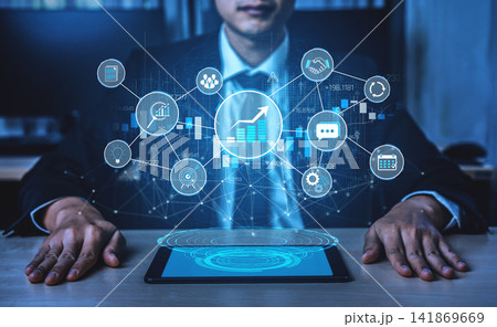 A business professional examines digital trends on a tablet, surrounded by a visual interface displaying graphs and analytics symbols, highlighting innovative technology solutions. Sigmoid A business professional examines digital trends on a tablet, surrounded by a visual interface displaying graphs and analytics symbols, highlighting innovative technology solutions. Sigmoid 141869669