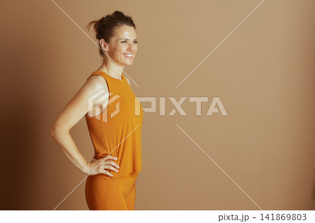 Smiling Woman Posing in Yellow Athleisure Smiling Woman Posing in Yellow Athleisure 141869803