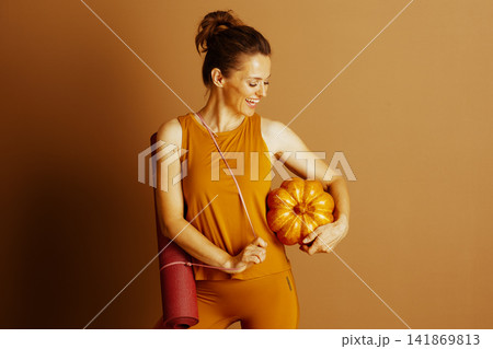 Middle-Aged Woman Embraces Autumn Wellness 141869813