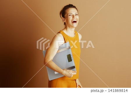 Happy Woman Laughing with Digital Scale Happy Woman Laughing with Digital Scale 141869814