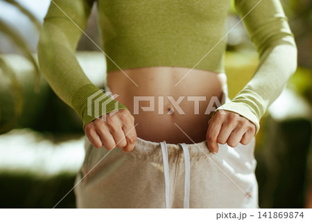 Close-Up of Woman Showing Weight Loss Results Close-Up of Woman Showing Weight Loss Results 141869874