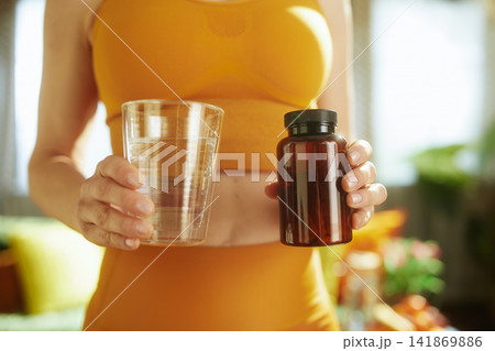 Woman Taking Daily Supplements with Water Woman Taking Daily Supplements with Water 141869886