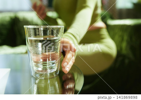 Woman in Green Sportswear Taking a Hydration Break Woman in Green Sportswear Taking a Hydration Break 141869898