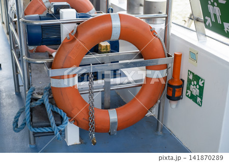 Orange lifebuoy on a yacht Orange lifebuoy on a yacht 141870289