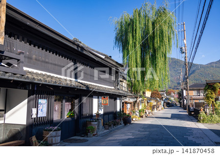 伝統的な町家と大きな柳の木が立ち並ぶ上田城下町柳町の石畳の通り 141870458