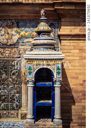 Vertical view of decorative ceramic tile column between provincial bench alcoves at Plaza of Spain in Seville Vertical view of decorative ceramic tile column between provincial bench alcoves at Plaza of Spain in Seville 141870692