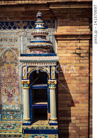 Vertical view of decorative ceramic tile column between provincial bench alcoves at Plaza of Spain in Seville Vertical view of decorative ceramic tile column between provincial bench alcoves at Plaza of Spain in Seville 141870697