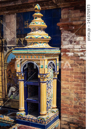 Vertical view of decorative ceramic tile column between provincial bench alcoves at Plaza of Spain in Seville Vertical view of decorative ceramic tile column between provincial bench alcoves at Plaza of Spain in Seville 141870973