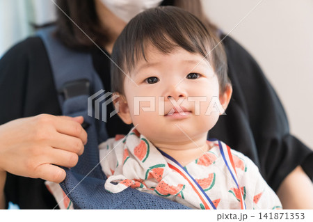 抱っこ紐でお祭りに参加するスイカ柄甚平の日本人の男の赤ちゃん 抱っこ紐でお祭りに参加するスイカ柄甚平の日本人の男の赤ちゃん 141871353