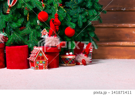 Cozy Christmas tree with festive decorations and gifts in a warm room 141871411