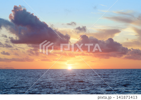 Majestic ocean sunset with vibrant clouds and calm sea surface Majestic ocean sunset with vibrant clouds and calm sea surface 141871413