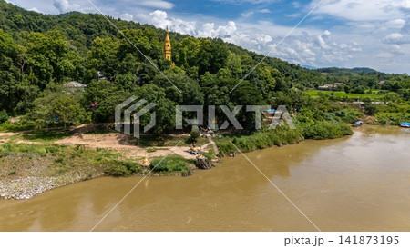 Aerial view of Buddhist pagoda located in Wat Phra That Doi Mae Ya Mon temple located nearly Mekong river in Chiang Khong district, Chiang Rai province, Thailand. Aerial view of Buddhist pagoda located in Wat Phra That Doi Mae Ya Mon temple located nearly Mekong river in Chiang Khong district, Chiang Rai province, Thailand. 141873195