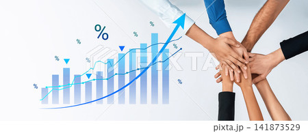 Hands of diverse individuals joining together above a rising graph symbolizing teamwork, growth, collaboration and success in business and finance sectors Cyphers. Hands of diverse individuals joining together above a rising graph symbolizing teamwork, growth, collaboration and success in business and finance sectors Cyphers. 141873529
