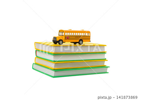 Toy bus on colorful school books, isolated on white, PNG Toy bus on colorful school books, isolated on white, PNG 141873869