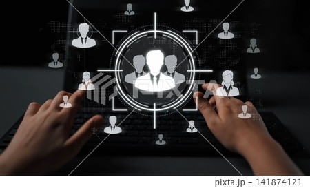 Two hands approach a digital interface displaying professional profiles, symbolizing online interactions and connections in a technologically advanced workspace. Sigmoid Two hands approach a digital interface displaying professional profiles, symbolizing online interactions and connections in a technologically advanced workspace. Sigmoid 141874121