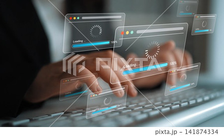 Digital Transformation Concept with Screens Showing Loading Indicators in a Business Environment While a Person Types on a Keyboard Gluon 141874334