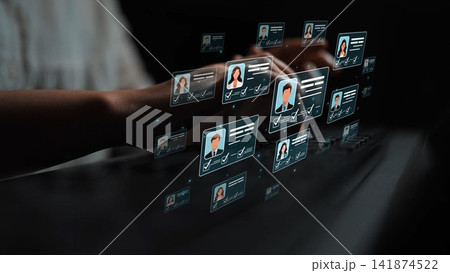 A modern digital interface showcasing virtual profiles and user cards while hands type on a keyboard. The image represents technology, data management, and user engagement concepts. Sigmoid A modern digital interface showcasing virtual profiles and user cards while hands type on a keyboard. The image represents technology, data management, and user engagement concepts. Sigmoid 141874522