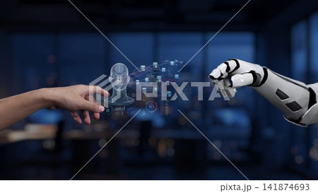 Human and robotic hand interaction in a modern office setting illustrating the future of technology, artificial intelligence, and collaboration between machine and human Synapse 141874693