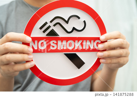 Male holding a no smoking sign. Male holding a no smoking sign. 141875288
