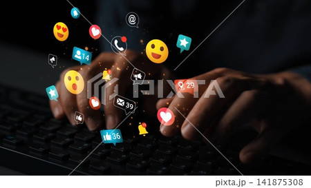 Digital interactions with social media icons floating above hands typing on a keyboard in a dark environment showcasing online communication and engagement Gluon Digital interactions with social media icons floating above hands typing on a keyboard in a dark environment showcasing online communication and engagement Gluon 141875308