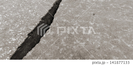 Gaps and deep cracks in the concrete slab surface. Gaps and deep cracks in the concrete slab surface. 141877133