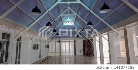 Modern Interior Hall with Gable Roof Truss and Hanging Industrial Lamps Modern Interior Hall with Gable Roof Truss and Hanging Industrial Lamps 141877582