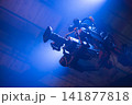 Professional movie camera on gimbal stabilizer rig with blue light copy space 141877818
