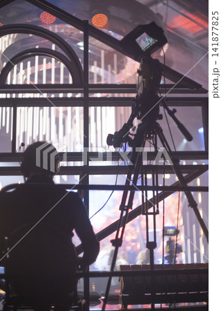 Cameraman with professional TV camera filming live concert on stage with copy space Cameraman with professional TV camera filming live concert on stage with copy space 141877825