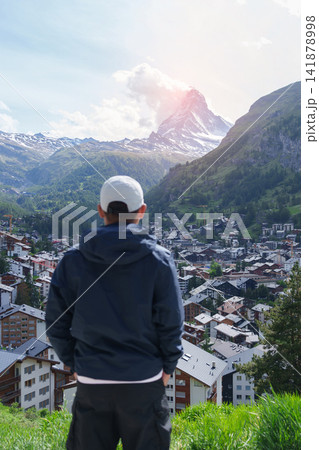 man Tourist Exploring Zermatt, Switzerland. Happy Traveler Visiting Zermatt Village Viewpoint and Matterhorn, Famous European Landmark, Popular Tourist Attraction and Travel Destination in Europe man Tourist Exploring Zermatt, Switzerland. Happy Traveler Visiting Zermatt Village Viewpoint and Matterhorn, Famous European Landmark, Popular Tourist Attraction and Travel Destination in Europe 141878998