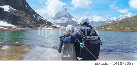 Couple Tourist Exploring Zermatt, Switzerland. happy hiker sightseeing iconic Matterhorn Swiss Alps at Riffelsee Lake, Famous European Landmark, Hiking Attraction and Travel Destination in Europe Couple Tourist Exploring Zermatt, Switzerland. happy hiker sightseeing iconic Matterhorn Swiss Alps at Riffelsee Lake, Famous European Landmark, Hiking Attraction and Travel Destination in Europe 141879058