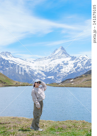 Woman Tourist Explore Grindelwald First, Switzerland in Summer. Hiker visit Bachalpsee Lake and Swiss Alps in Jungfrau Region. Famous Traveler Attraction, Travel Destination and hiking trail in Europe Woman Tourist Explore Grindelwald First, Switzerland in Summer. Hiker visit Bachalpsee Lake and Swiss Alps in Jungfrau Region. Famous Traveler Attraction, Travel Destination and hiking trail in Europe 141879105