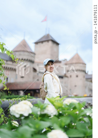 Woman Tourist Explore Chateau de Chillon, Montreux, Switzerland in Summer. Traveler Visit the Historic Medieval Castle on Lake Geneva, Famous European Tourist Attraction and Europe Travel Destination Woman Tourist Explore Chateau de Chillon, Montreux, Switzerland in Summer. Traveler Visit the Historic Medieval Castle on Lake Geneva, Famous European Tourist Attraction and Europe Travel Destination 141879111