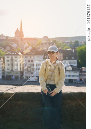 Woman Tourist Exploring Zurich, Switzerland in Summer. Traveler Visit Lindenhof Hill Viewpoint Over Zurich Old Town and Limmat River, Famous European Tourist Attraction and Europe Travel Destination 141879127